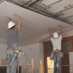 Installing drywall on a drywall suspension ceiling grid system
